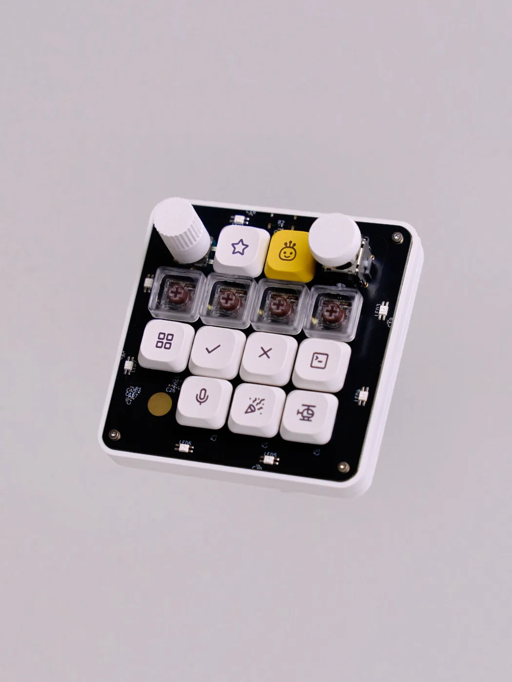 Close-up of the finished board showing per-key lighting, perimeter underglow, the knob, the joystick and the capacitive touch pad